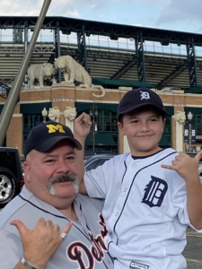 Chief Mike Fronimos and his son shown supporting U of M and the Detroit Tigers.